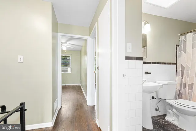 a bathroom with a toilet a sink and a mirror