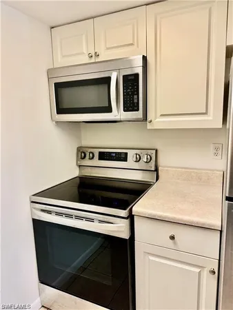 a kitchen with a stove and a microwave
