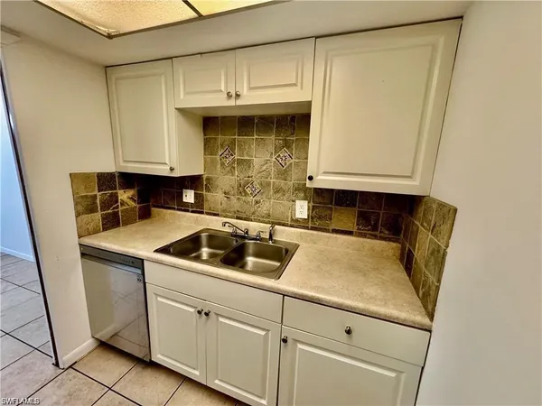 a kitchen with stainless steel appliances a sink and a refrigerator