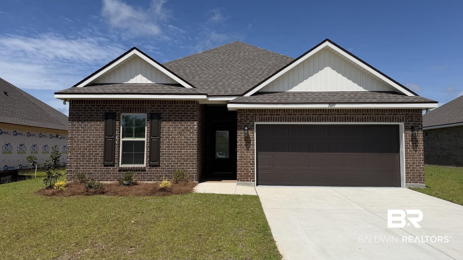 18149 Piney Circle Foley, AL 36535 - Photo 1 of 3 Brick facade home featuring a two-car garage, concrete driveway, and front lawn with foundational plantings
