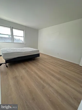 a view of a livingroom with an empty space and a window