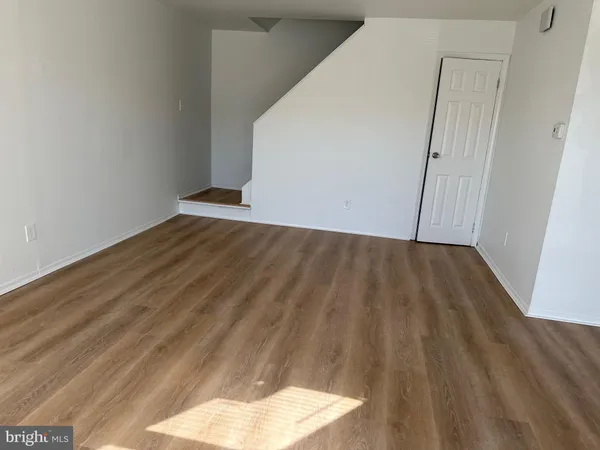 a view of a room with wooden floor