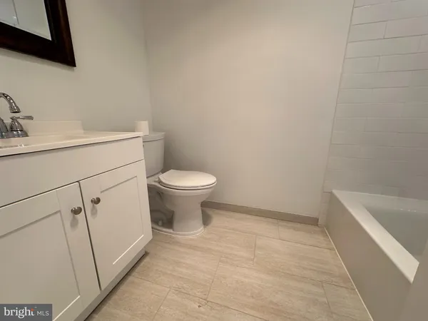 a bathroom with a sink a toilet and vanity