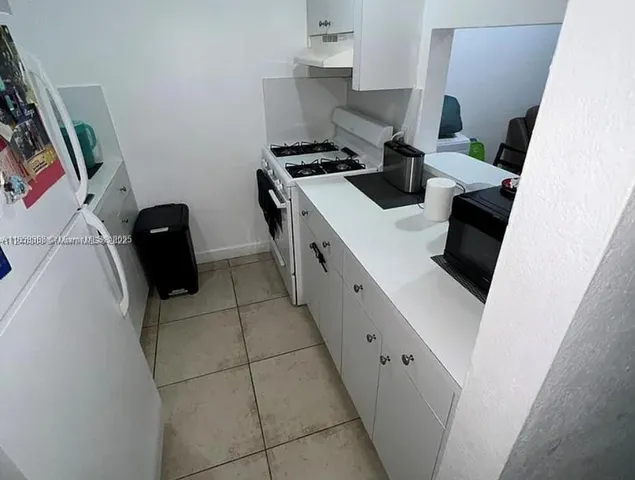 a kitchen with a stove and a refrigerator