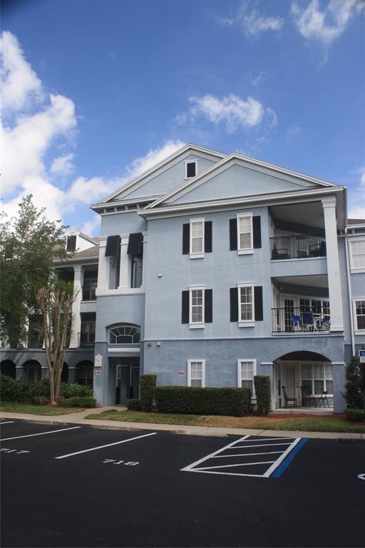3621 Conroy Road, Unit 739 Orlando, FL 32839 - Photo 2 of 20 a front view of a building with lot of trees and plants