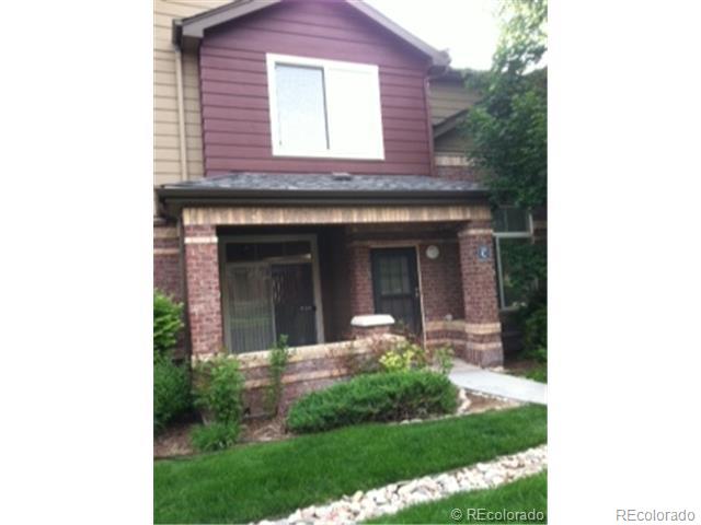 a view of a house with potted plants and a bench