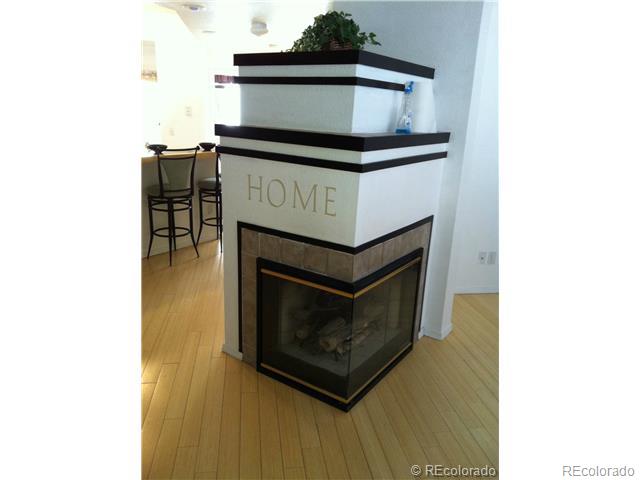 6428 Silver Mesa Drive, Unit C Highlands Ranch, CO 80130 - Photo 2 of 7 a living room with a stove and a microwave