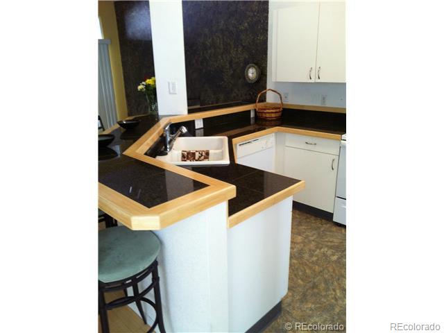 6428 Silver Mesa Drive, Unit C Highlands Ranch, CO 80130 - Photo 3 of 7 a kitchen with a sink and cabinets
