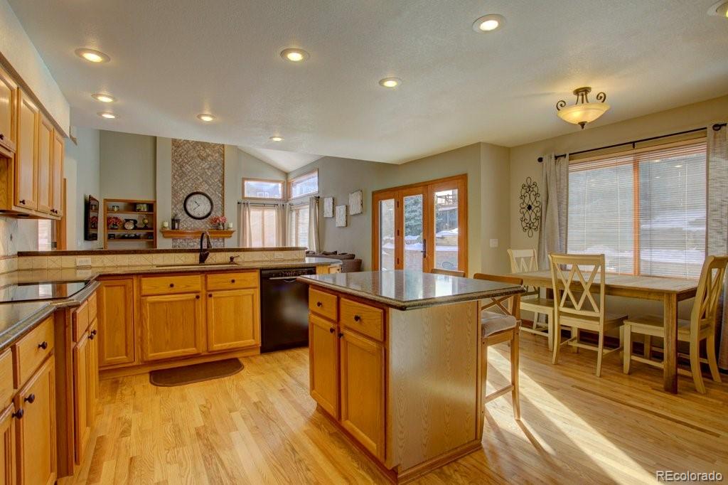 2364 Stratford Court Highlands Ranch, CO 80126 - Photo 11 of 35 a kitchen with stainless steel appliances granite countertop a stove and a view of living room