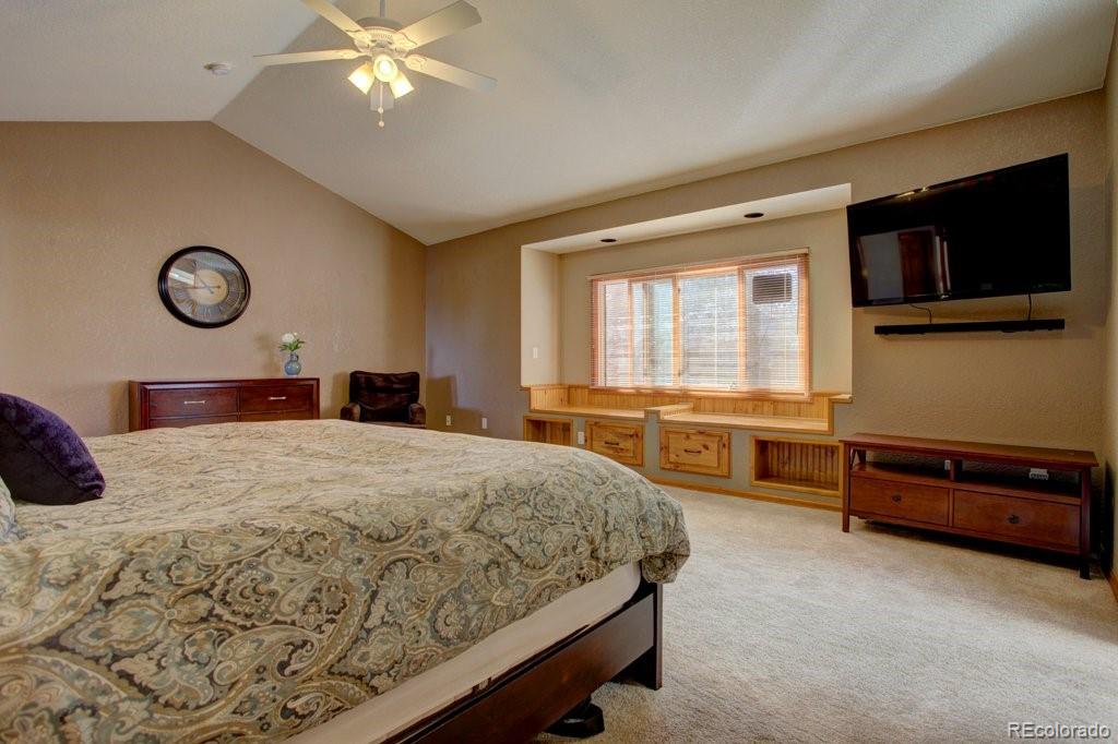 2364 Stratford Court Highlands Ranch, CO 80126 - Photo 22 of 35 a bedroom with a bed and a chandelier