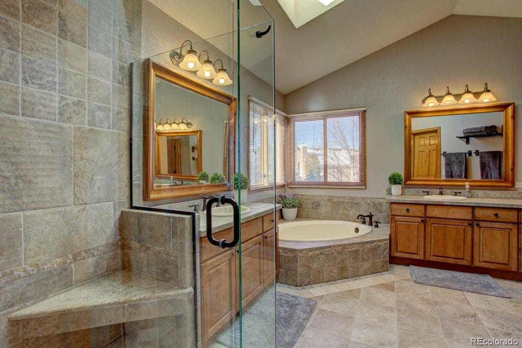 2364 Stratford Court Highlands Ranch, CO 80126 - Photo 23 of 35 a bathroom with a tub a sink and mirror