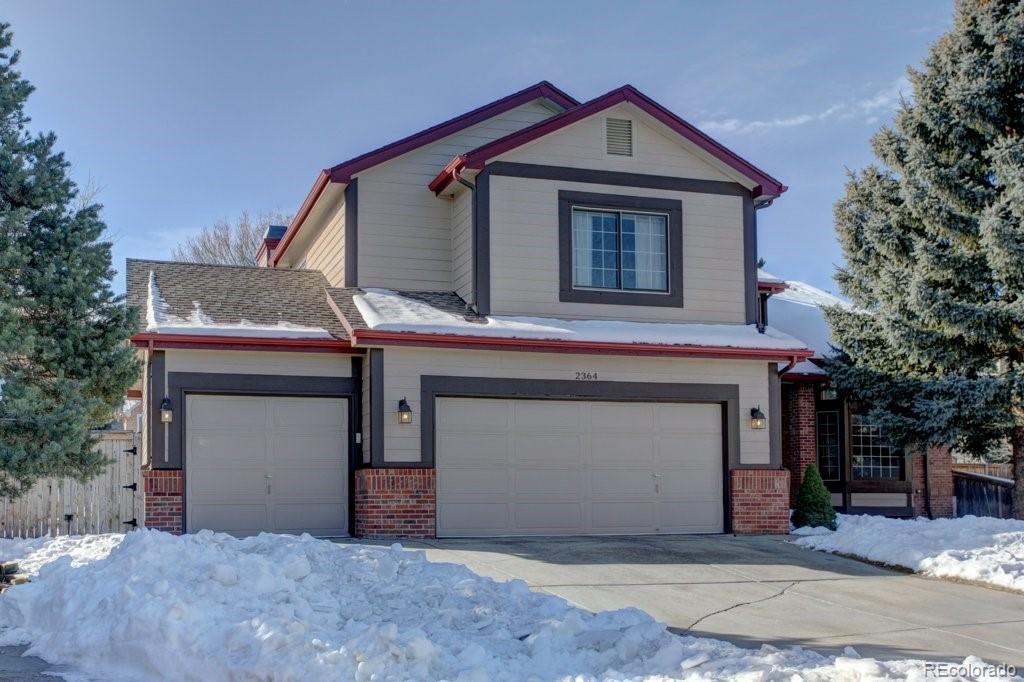 2364 Stratford Court Highlands Ranch, CO 80126 - Photo 35 of 35 a view of a house with a yard and garage
