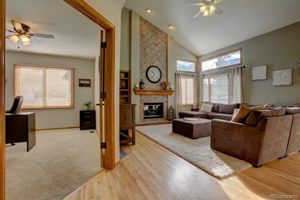 2364 Stratford Court Highlands Ranch, CO 80126 - Photo 4 of 35 a living room with furniture fireplace and a large window