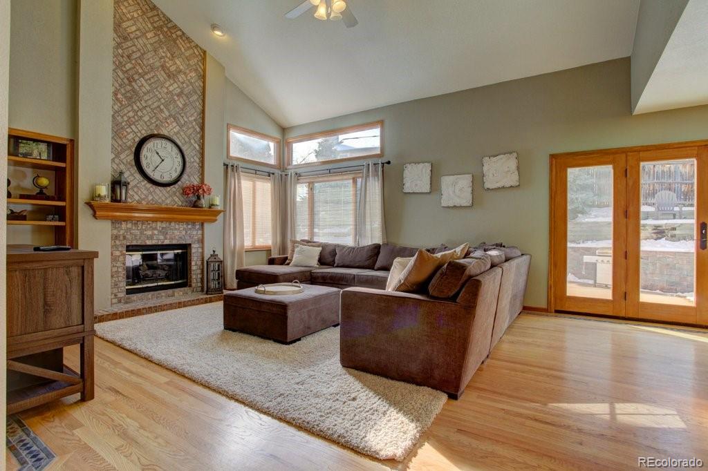 2364 Stratford Court Highlands Ranch, CO 80126 - Photo 6 of 35 a living room with furniture a large window and a fireplace