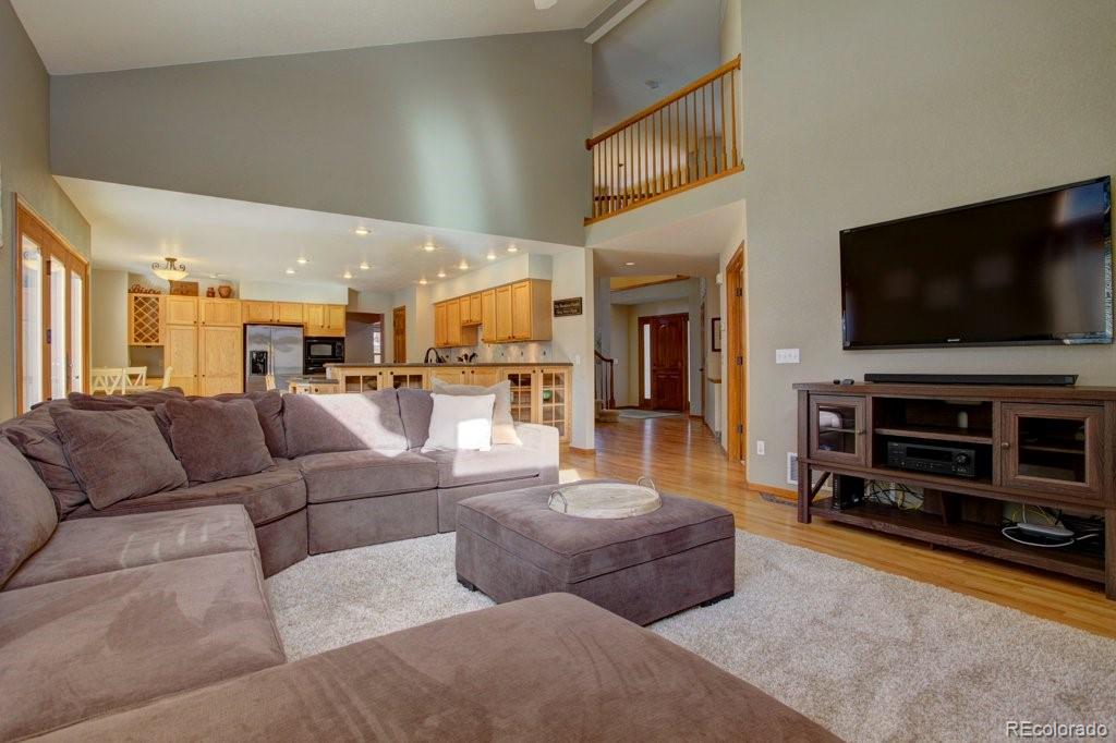 2364 Stratford Court Highlands Ranch, CO 80126 - Photo 8 of 35 a living room with furniture and a flat screen tv