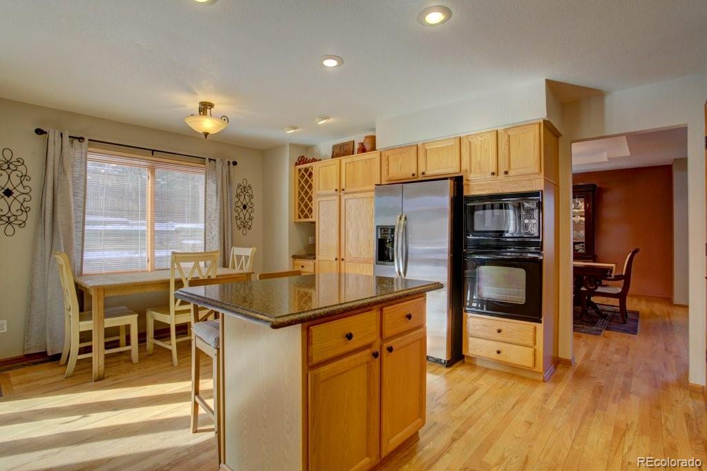 2364 Stratford Court Highlands Ranch, CO 80126 - Photo 10 of 35 a kitchen with stainless steel appliances granite countertop a sink and a refrigerator