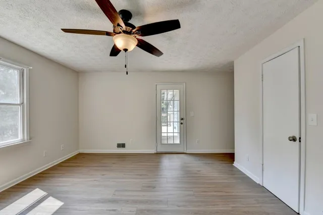 wooden floor in an empty room with a window