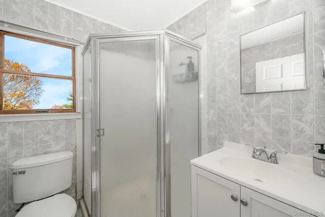 a bedroom with a bed and a flat tv screen on the dresser