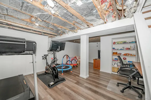a view of a workspace with furniture and wooden floor