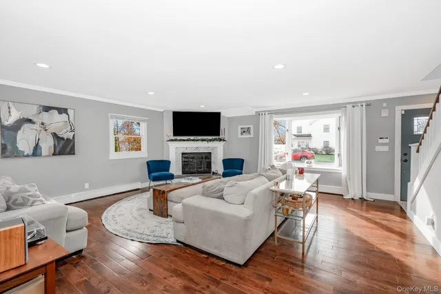 a living room with furniture a fireplace and a flat screen tv