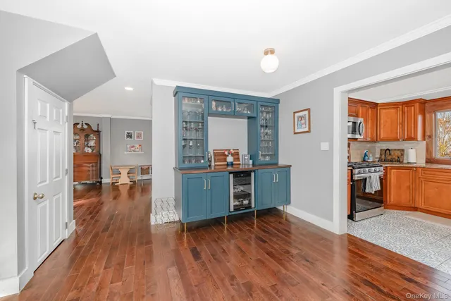 a dining room with furniture a chandelier and wooden floor