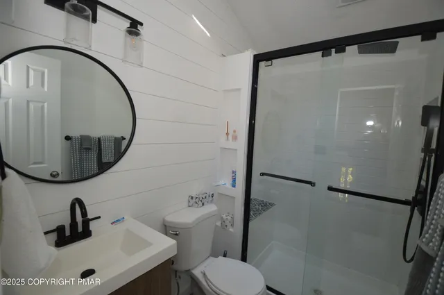 a bathroom with a sink toilet and a mirror