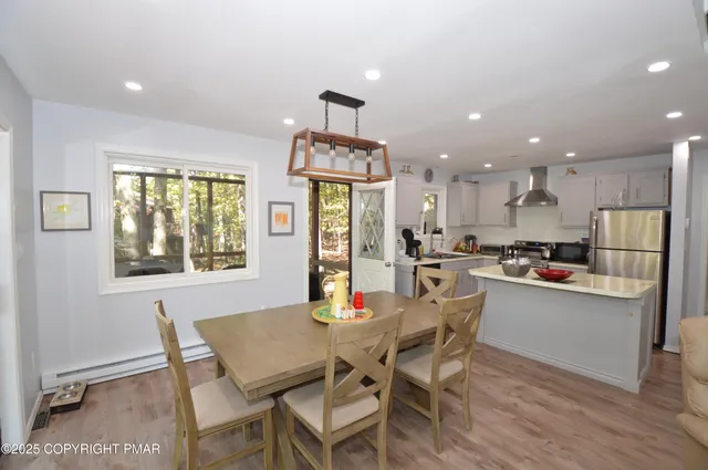 a view of a dining room with furniture large window and wooden floor