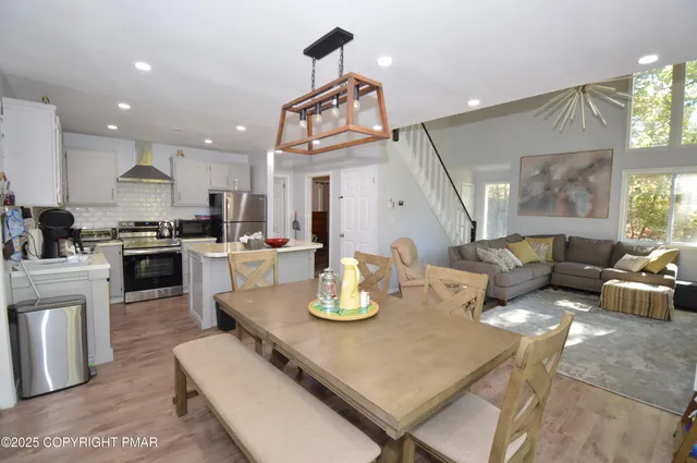 a living room with kitchen island furniture and a wooden floor