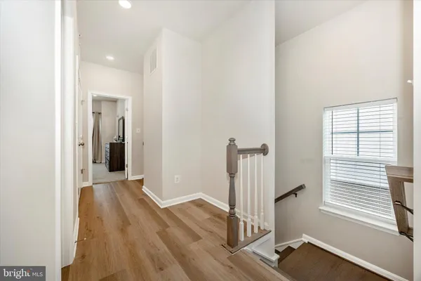 a view of hallway with wooden floor