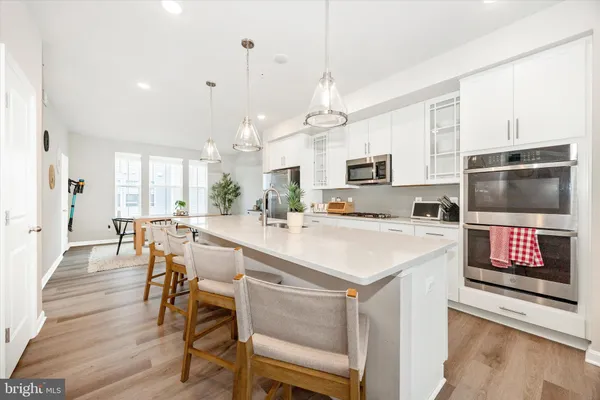 a kitchen with a stove a sink and a refrigerator