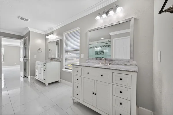 a bathroom with a glass shower door