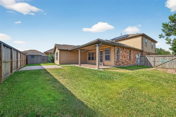 a view of a house with backyard and porch
