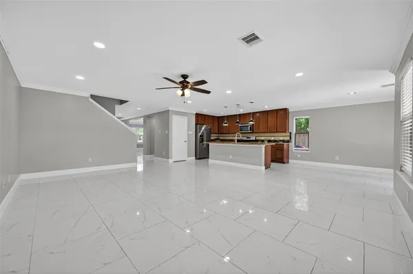 a view of a kitchen with a dishwasher and white cabinets