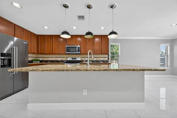 a open kitchen with white cabinets and stainless steel appliances
