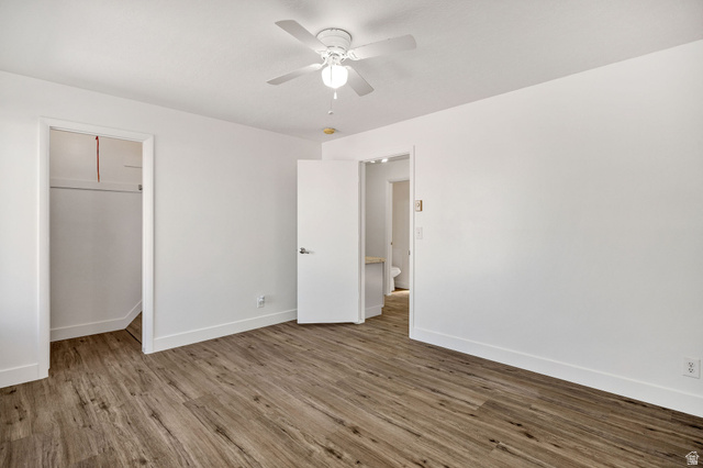 283 West 600 North, Unit 2 Logan, UT 84321 - Photo 20 of 36 Spacious room featuring wood-finish flooring, white walls, and a ceiling fan
