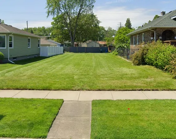 a view of a garden with a house