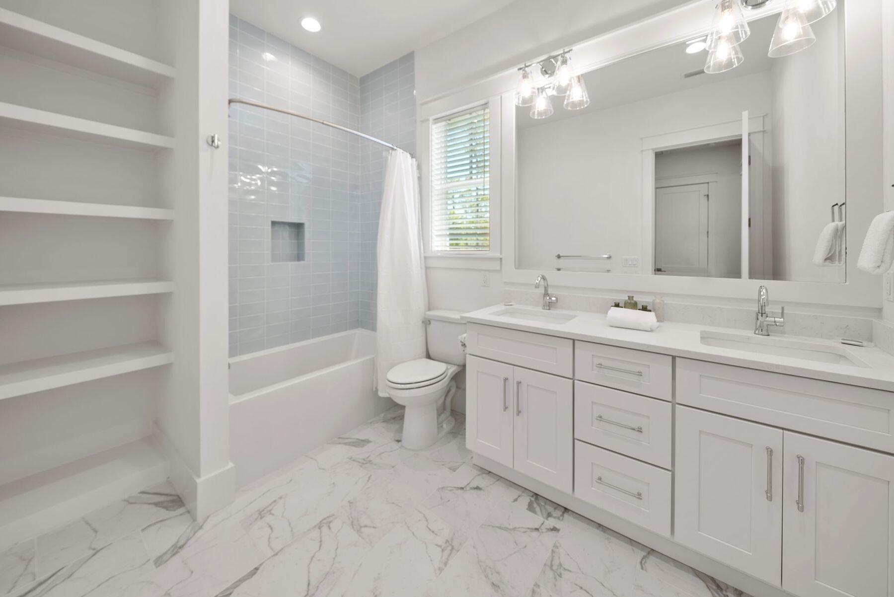 23 Sweet Gum Loop Inlet Beach Inlet Beach, FL 32461 - Photo 25 of 35 a bathroom with a double vanity sink toilet mirror and bathtub