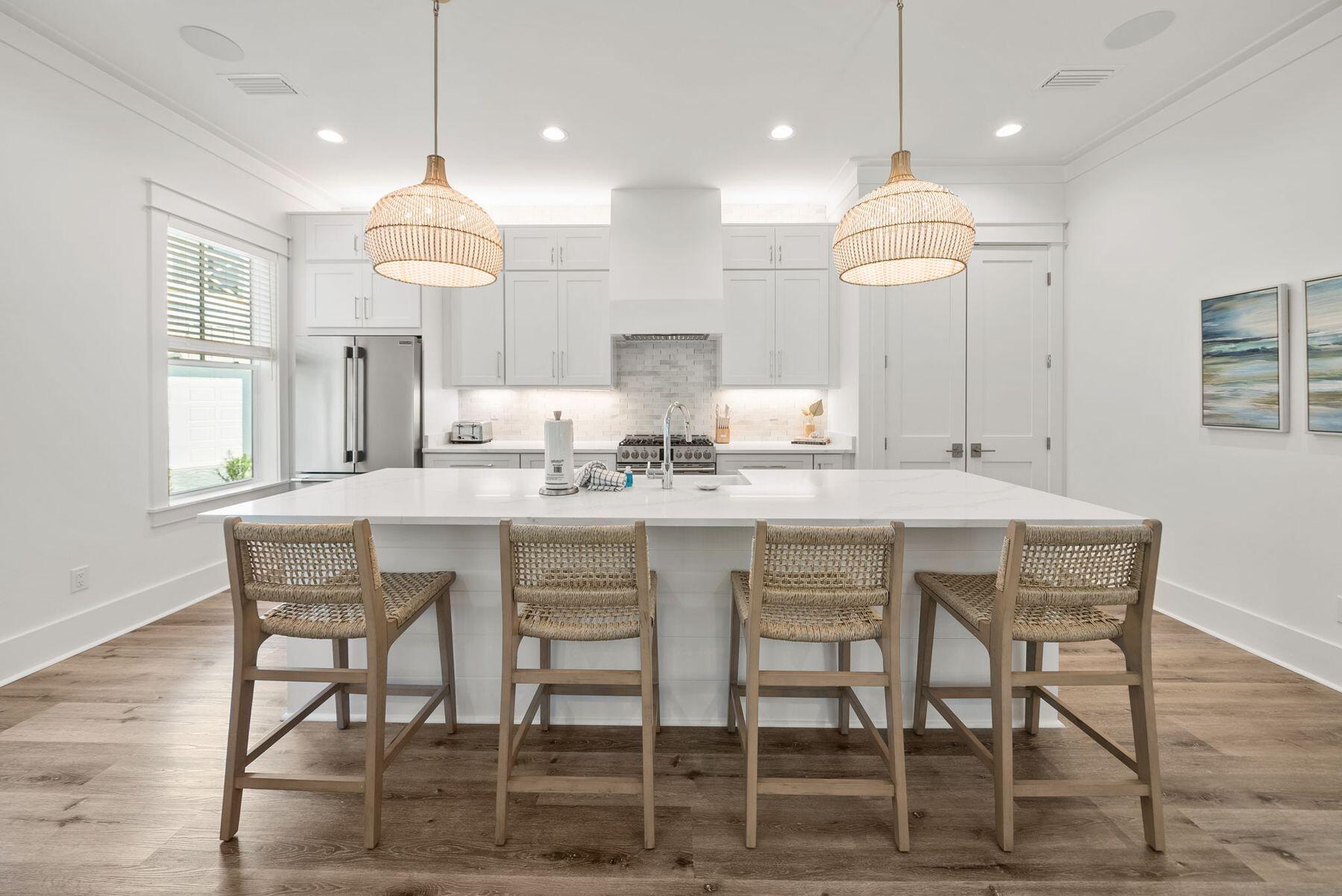 23 Sweet Gum Loop Inlet Beach Inlet Beach, FL 32461 - Photo 5 of 35 a kitchen with kitchen island granite countertop a table and chairs in it