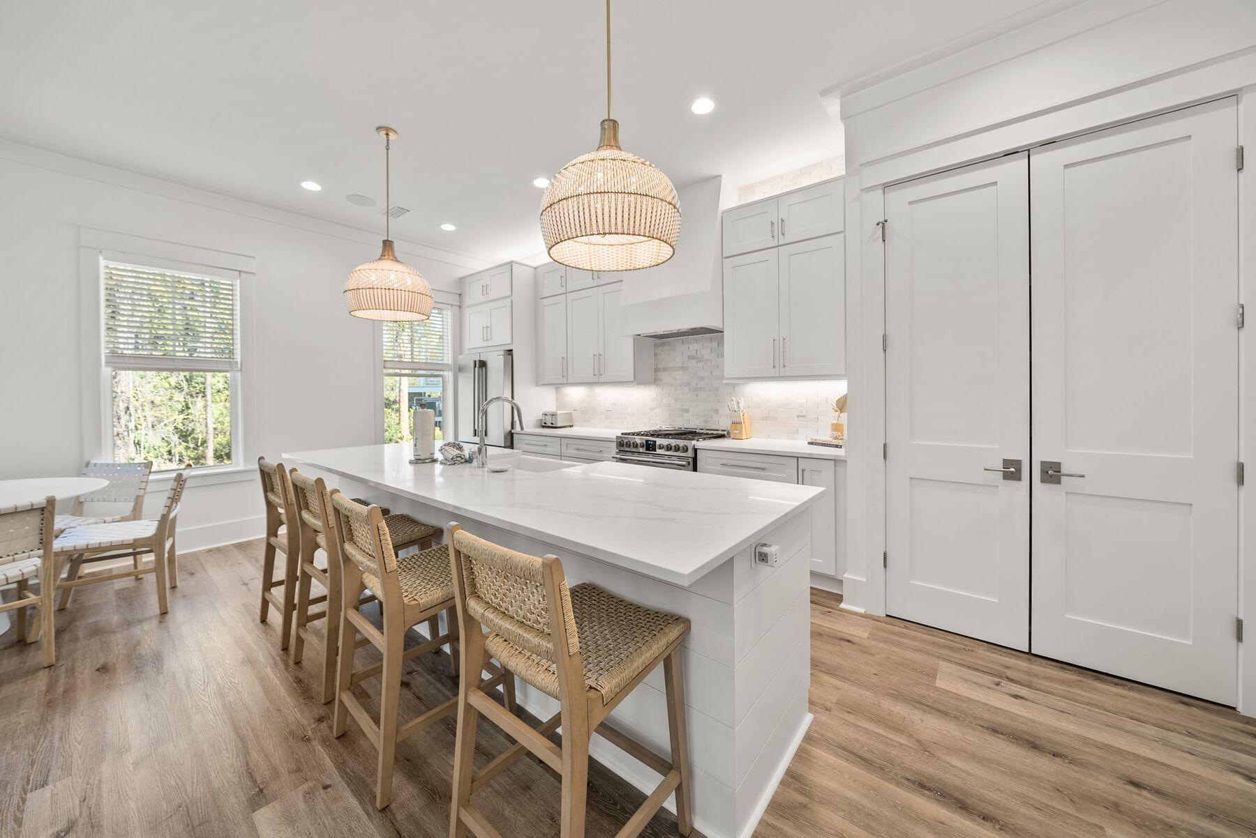 23 Sweet Gum Loop Inlet Beach Inlet Beach, FL 32461 - Photo 6 of 35 a kitchen with a table chairs and white cabinets