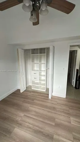 en empty room with fan and window