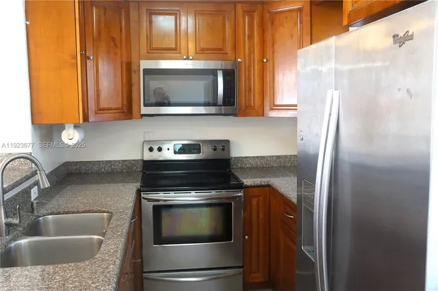 a kitchen with a sink and a microwave