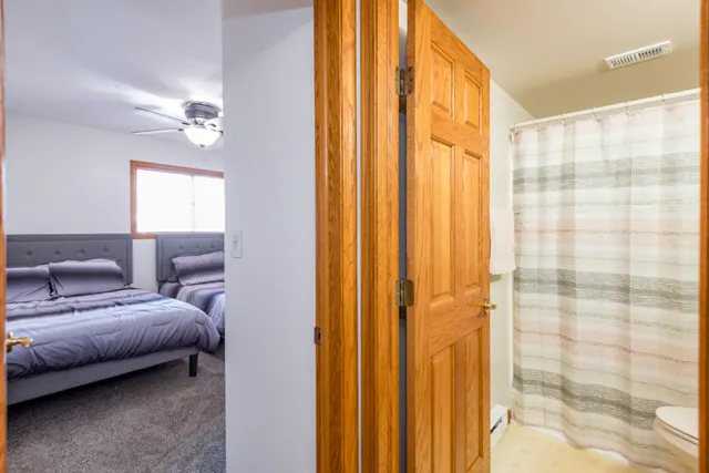 a bedroom with a bed and a chandelier