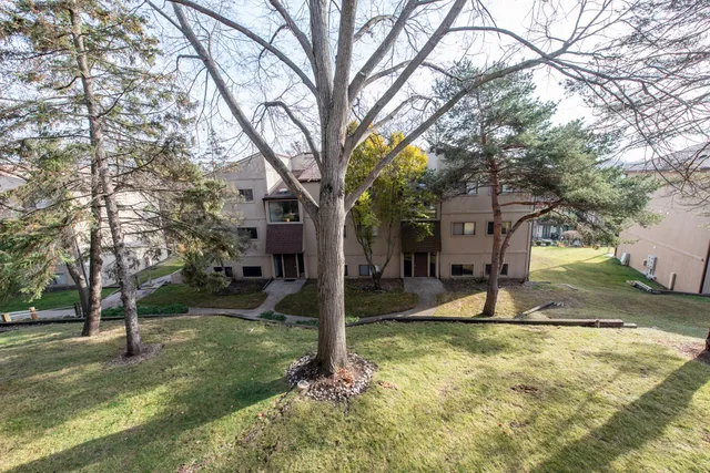 a view of a yard in front of house with trees