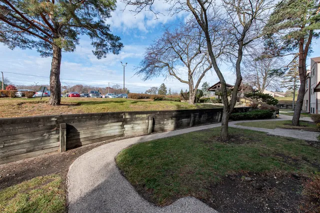 a view of a swimming pool with a patio and a yard