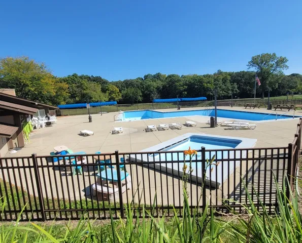 a view of swimming pool with deck and yard