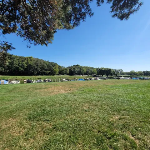 a view of a lake with houses in the back
