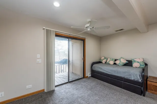 a living room with a bed furniture and a window