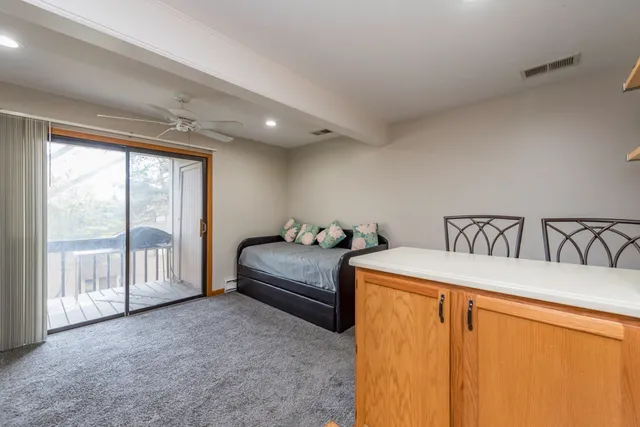 a bedroom with a bed and a large window