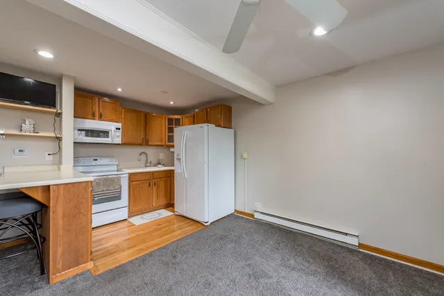 a kitchen with stainless steel appliances granite countertop a refrigerator and a sink