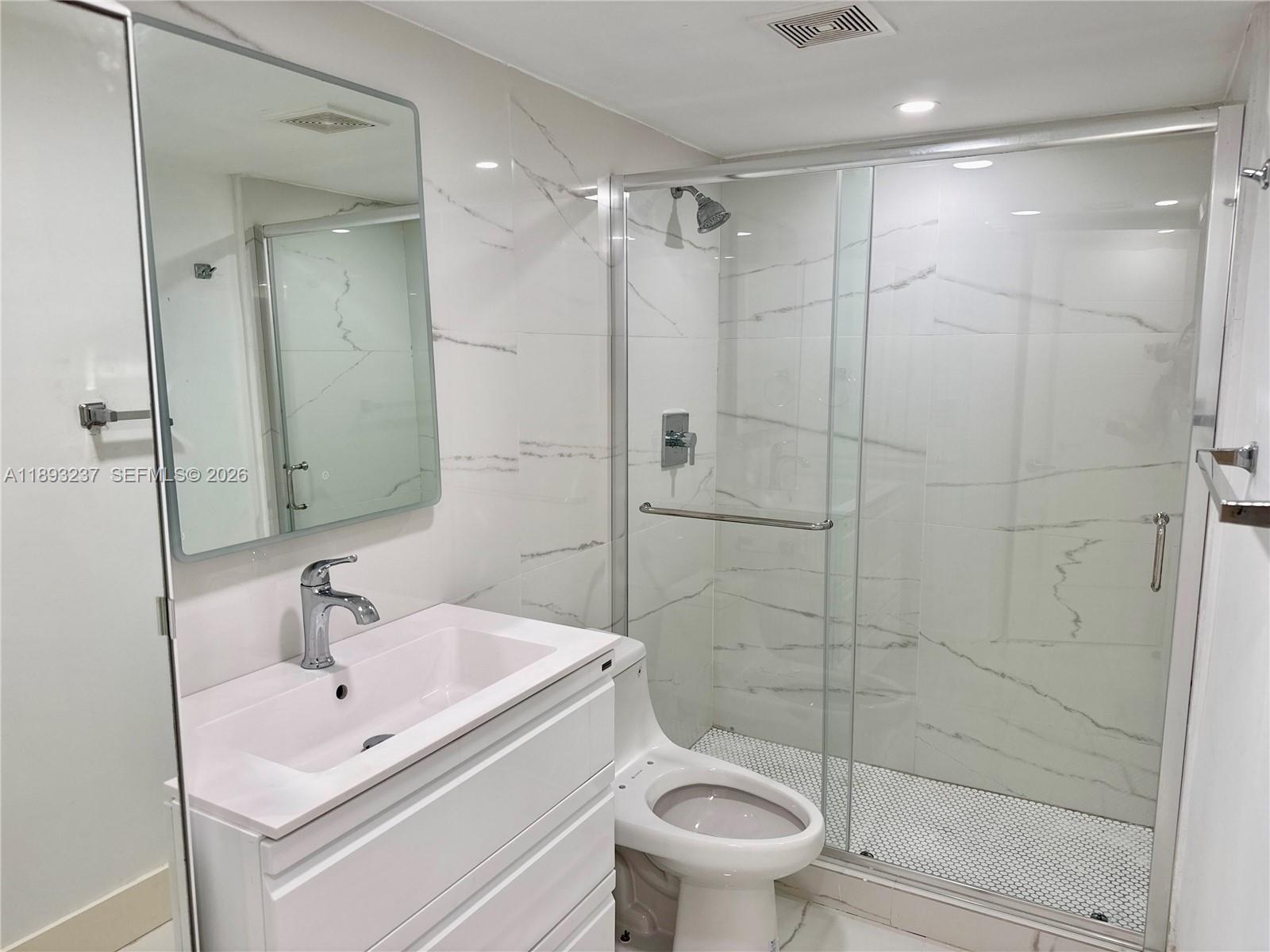 5415 Collins Avenue, Unit 304 Miami Beach, FL 33140 - Photo 11 of 20 a bathroom with a sink toilet and shower